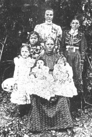 Mary Phagan's mother, Fannie Phagan Coleman (center), with her family in Atlanta, 1902. She holds Mary (right) and another child. Mary Phagan's older sister, Ollie Mae, stands at front left.